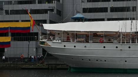 Colombian-Flags-next-to-Juan-Sebastián-de-Elcano,-Canary-Wharf,-London,-United-Kingdom