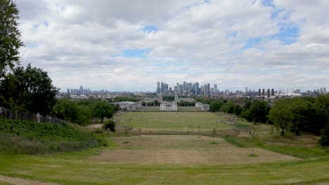 Greenwich,-London:-View-of-Greenwich-Park-from-the-Greenwich-Observatory,-with-the-Canary-Wharf-skyline-in-the-background