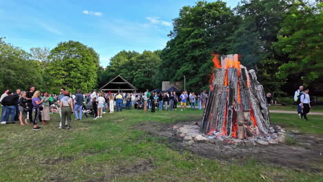 Slow-motion-landscape-crowd-of-people-outdoors-at-Midsummer's-Eve-bonfire-historic-event-celebrations-in-Estonian-Open-Air-Museum-Tallinn-Europe