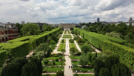 Drone-flying-over-Jardin-des-Plantes-or-Garden-of-Plants-with-Gallery-of-Evolution-in-background,-Paris-in-France