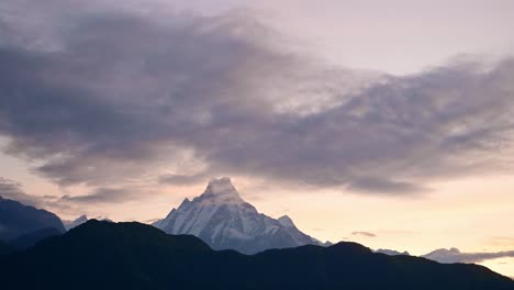 Sunset-Sky-and-Clouds-over-Mountains-in-Nepal,-Snowcapped-Annapurna-Mountains-Landscape-in-Dramatic-Himalayas-Scenery-with-Fishtail-Mountain-Top-at-Poon-Hill-on-Trek-while-Trekking-and-Hiking-in-Nepal