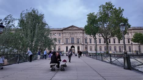 Pedestrians-walking-on-Pont-des-Arts-bridge-in-Paris-toward-Insititute-de-France