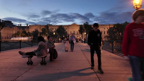 First-person-view-walk-on-Pont-des-Arts-of-Paris-with-people-and-tourists-at-sunset