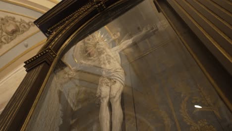 Close-up-of-a-crucifix-in-an-ornate-church,-showcasing-detailed-craftsmanship-and-spiritual-ambiance