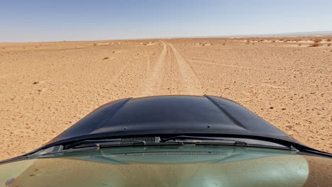 Driving-through-the-endless-sandy-expanse-of-the-Sahara-Desert-near-Merzouga