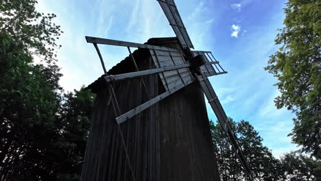 Old-wooden-windmill-with-large-blades-against-a-vibrant-blue-sky-in-Rocca-al-Mare,-Tallinn,-Estonia