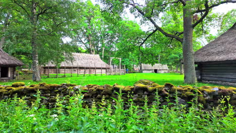 Traditional-Estonian-village-in-Rocca-al-Mare-surrounded-by-lush-greenery-and-moss-covered-stone-walls