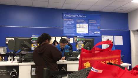 Motion-of-people-returning-items-at-customer-service-counter-inside-Walmart-store-with-4k-resolution