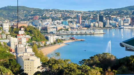 Aerial-cityscape-overlooking-the-capital-city-of-Wellington-with-skyscrapers,-Oriental-Bay-beach-and-harbour-in-New-Zealand-Aotearoa