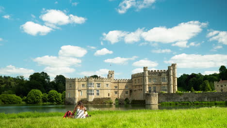 Wide-shot-time-lapse-of-picnic-scene-in-Leeds-Castle,-with-drifting-clouds-and-peaceful-scene