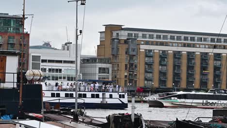 Party-Boat-and-MBNA,-Uber-Boat-on-the-Thames,-London,-United-Kingdom