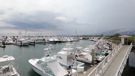 Safely-docked-sportfishing-boats-and-yachts-at-Marina-Pez-Vela-before-the-tropical-storm-in-Quepos,-Costa-Rica