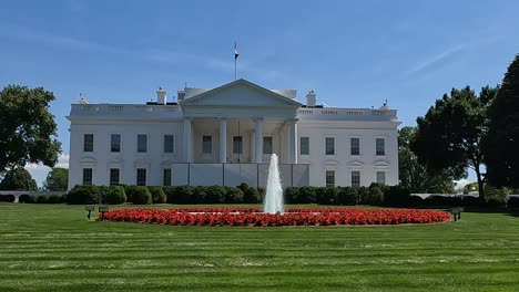 USA-White-House-shot-with-a-slow-vertical-tilting-shot-from-the-front-view-with-a-water-fountain-in-the-middle-of-flowers-shot-in-4K-during-the-early-summer,-midday-of-May-2024