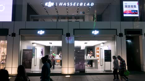 Pedestrians-pass-by-DJI's-official-store-in-Hong-Kong,-where-the-Chinese-technology-company-renowned-for-its-drones-attracts-numerous-customers