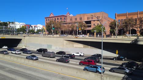 Los-Angeles-USA,-Traffic-on-US-101-Highway,-Merced-Theater-and-Chinese-American-Museum-Buildings