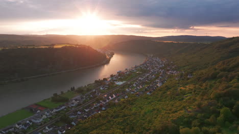 Flying-over-the-hills-of-Braubach,-Germany-with-the-sunsetting-over-the-Rhine-river