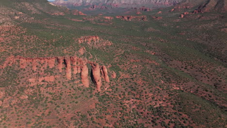 Camera-begins-on-red-rock-formation,-then-pulls-back-and-tilts-up-to-reveal-the-Sedona-desert-landscape-with-red-rock-formations