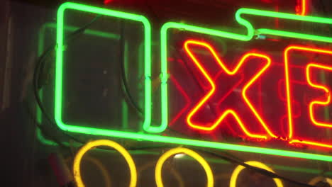 Pan-across-neon-sign-in-Chinatown-store-window