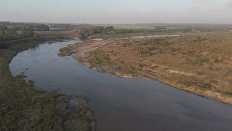 Drone-descends-over-the-water-of-a-seasonal-river-in-the-Kruger-national-park