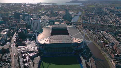 Cardiff-city-Millennium-stadium-descending-aerial-view-over-Welsh-sunrise-capital-cityscape