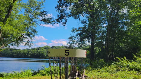 Wide-Tilt-Down-of-a-Disc-Golf-Basket-at-a-Park