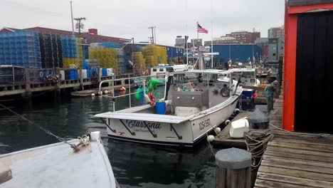 Lobster-boats-at-lobster-traps-on-pier-at-Portland,-Maine-working-waterfront