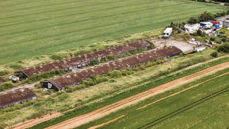 Desolate-military-facility-aerial-view,-empty-storage-buildings-of-Bradwell-airport