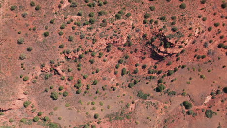 Camera-looks-straight-down-and-moves-from-left-to-right-over-the-Sedona,-AZ-desert