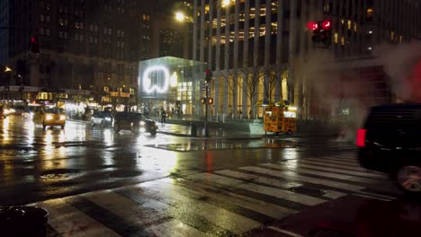 Shot-of-square-with-commercial-technology-store-on-5th-avenue-during-a-rainy-evening-in-New-York-City