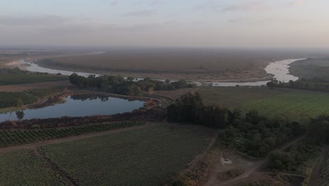 Drone-view-of-seasonal-or-ephemeral-crocodile-river-by-sugarcane-farmlands-bordering-the-Kruger-National-Park