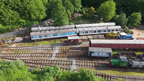 Aerial-view-circling-above-Northamptonshire-ironstone-railway-freight-carriages-on-disused-tracks