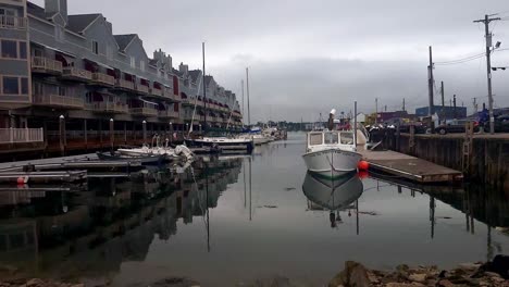 Lobster-boats-at-lobster-traps-on-pier-at-Portland,-Maine-working-waterfront