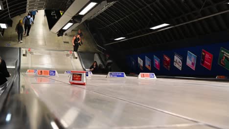 Going-down-the-escalator-in-Central-London,-United-Kingdom