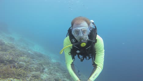 A-diver-takes-a-selfie-against-deep-blue-water