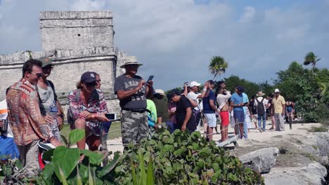 Tourists-look-out-to-Caribbean-sea-at-Tulum-Mayan-Ruins-in-Mexico