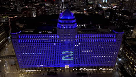 Aerial-view-of-the-illuminated-ART-on-the-MART,-Digital-Art-Platform-in-Chicago