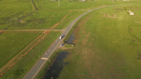 Driving-On-The-Countryside-Road-Overlooking-Town-In-Kazakhstan,-Central-Asia