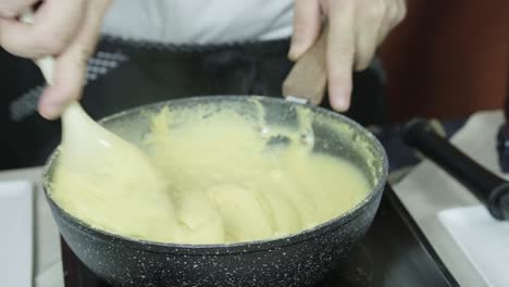 Chef-mixes-dough-batter-mixture-on-stove-to-prepare-to-make-panelle-or-panella