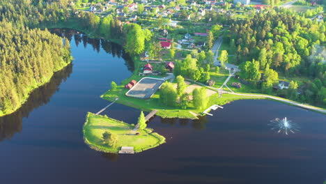 Aerial-view-of-a-picturesque-Lake-Teperis-surrounded-by-lush-greenery-and-a-small-island-in-Smiltene