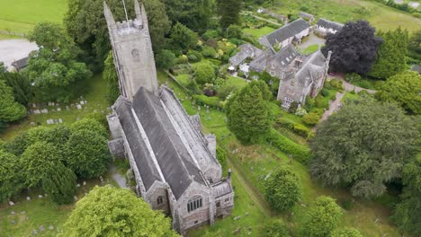 Aerial-view-of-All-Saints-Church-and-surrounding-area-outside-of-Okehampton,-Devon,-UK,-captured-in-July-2024