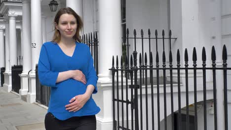 Beautiful-pregnant-caucasian-woman-strolling-down-street-in-central-London