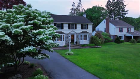 Drone-approaching-shot-of-upper-class-single-family-homes-in-green-district-of-american-town