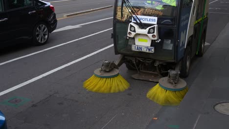 Council-street-sweeper-vehicle-patrolling-around-Melbourne-city,-cleaning-and-maintenance-the-streets-in-the-central-business-district