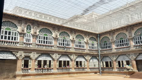 Mysore-Palace-courtyard-during-daytime,-tourists-taking-photos,-India