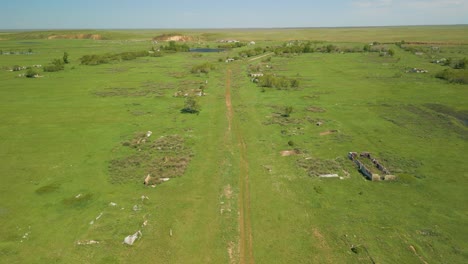 Isolated-View-Of-Abandoned-Structure-Ruins-In-Green-Meadow-Landscape