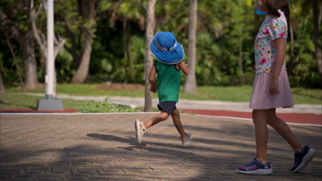 Cámara-Lenta-De-Un-Joven-Latino-Mexicano-Con-Un-Sombrero-Azul-Jugando-Corriendo-Con-Sus-Amigos-En-El-Parque-En-México