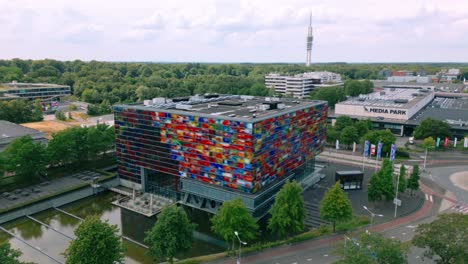 Footage-captures-the-exterior-of-the-Netherlands-Institute-for-Sound-and-Vision-at-Media-Park-Hilversum,-showcasing-its-colorful-glass-facade-and-modern-design