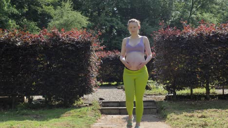 Pregnant-caucasian-woman-walking-through-garden