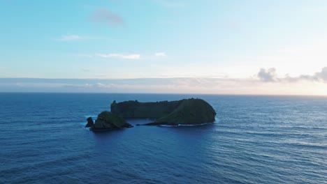 Blue-water-flows-calm-under-Portuguese-Azores-islet,-aerial-drone-fly-ocean-skyline-in-tranquil-daylight