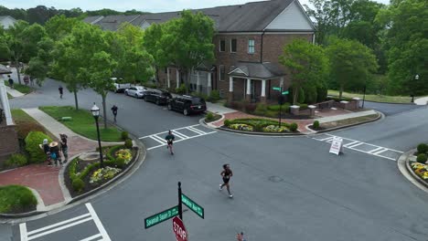 Aerial-approaching-shot-of-running-event-in-american-town